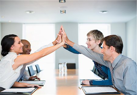 successful business woman arms raised with joy - Business people high fiving in office Photographie de stock - Premium Libres de Droits, Code: 6113-07242776