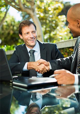Businessmen shaking hands outdoors Stock Photo - Premium Royalty-Free, Code: 6113-07242729