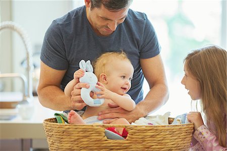 Father and children sorting laundry Stock Photo - Premium Royalty-Free, Code: 6113-07242870