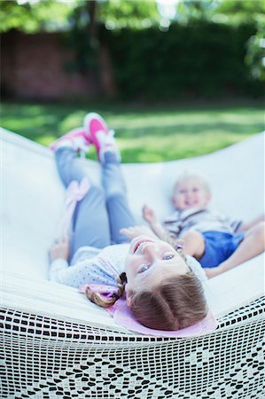 Children relaxing in hammock outdoors Stock Photo - Premium Royalty-Free, Code: 6113-07242872