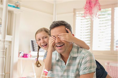 preteen girl surprise - Father and daughter playing peek-a-boo Stock Photo - Premium Royalty-Free, Code: 6113-07242886