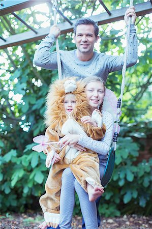 dad girl dress up - Father and children playing together on swing Stock Photo - Premium Royalty-Free, Code: 6113-07242818