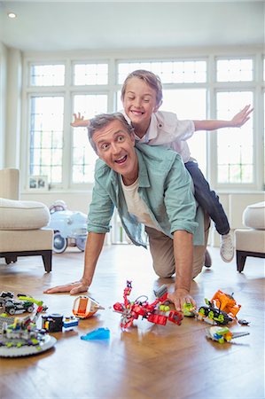 Father and son playing together Stock Photo - Premium Royalty-Free, Code: 6113-07242820