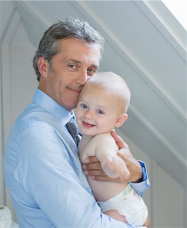smiling baby portrait - Father holding baby indoors Photographie de stock - Premium Libres de Droits, Code: 6113-07242824