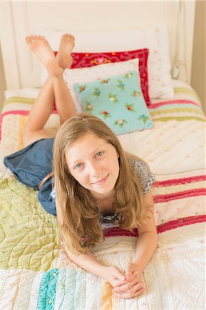 preteen girl bedroom - Girl laying on bed Stock Photo - Premium Royalty-Free, Code: 6113-07242833