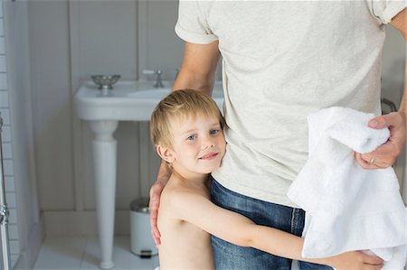 son on father - Boy hugging father in bathroom Stock Photo - Premium Royalty-Free, Code: 6113-07242953