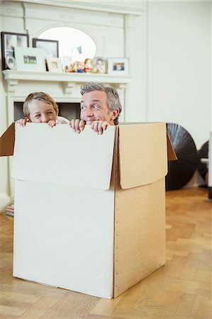 fun family toys - Father and son playing in cardboard box Stock Photo - Premium Royalty-Free, Code: 6113-07242969