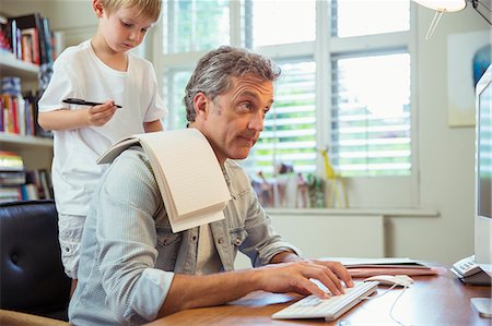 drawing (activity) - Son distracting father at work in home office Stock Photo - Premium Royalty-Free, Code: 6113-07242981