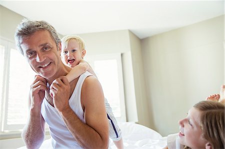 piggy back ride boys - Father and children playing on bed Stock Photo - Premium Royalty-Free, Code: 6113-07242920