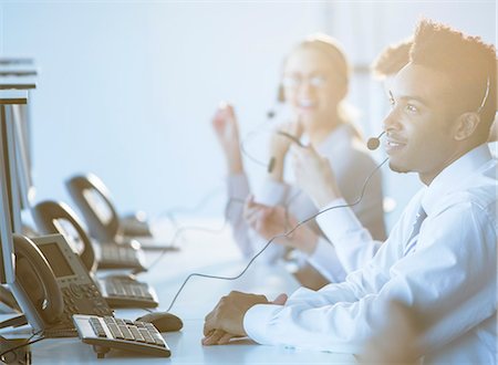 simsearch:6113-08550021,k - Businessman talking on headset in office Stock Photo - Premium Royalty-Free, Code: 6113-07243040