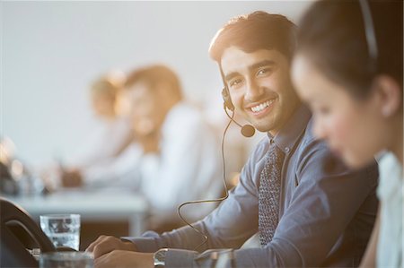 desk female - Businessman wearing headset in office Stock Photo - Premium Royalty-Free, Code: 6113-07243041