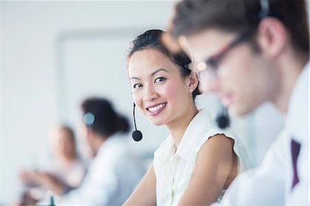 Businesswoman wearing headset in office Stock Photo - Premium Royalty-Free, Code: 6113-07243046