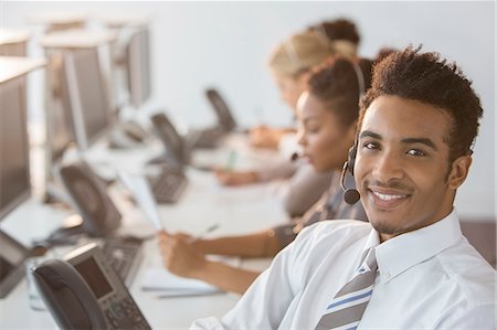 simsearch:6113-07243080,k - Businessman wearing headset in office Stock Photo - Premium Royalty-Free, Code: 6113-07243054