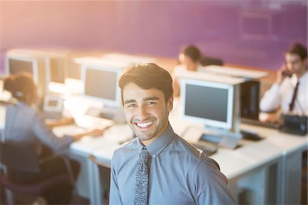 Businessman smiling in office Stock Photo - Premium Royalty-Free, Code: 6113-07243062