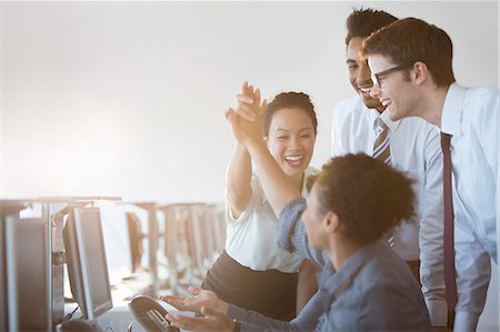 success and teamwork - Business people cheering in office Stock Photo - Premium Royalty-Free, Code: 6113-07243067