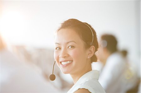 phonecall - Businesswoman wearing headset in office Stock Photo - Premium Royalty-Free, Code: 6113-07243066