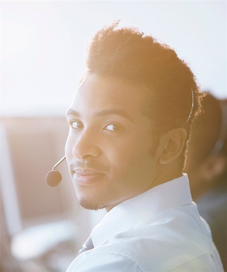 Businessman wearing headset in office Stock Photo - Premium Royalty-Free, Image code: 6113-07243068