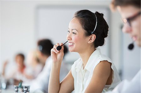 simsearch:6113-07243039,k - Businesswoman wearing headset in office Stock Photo - Premium Royalty-Free, Code: 6113-07243071