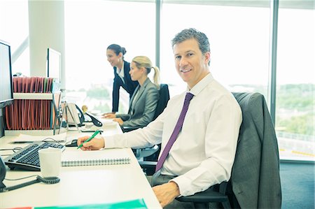 simsearch:6113-07242192,k - Businessman working at desk in office Stock Photo - Premium Royalty-Free, Code: 6113-07243088