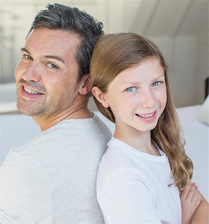 preteen girl joy - Father and daughter smiling in bedroom Stock Photo - Premium Royalty-Free, Code: 6113-07243018