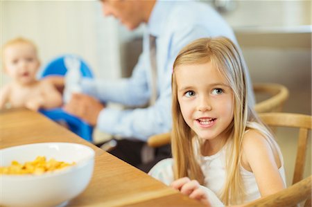 simsearch:6113-07242954,k - Girl sitting at breakfast table Stock Photo - Premium Royalty-Free, Code: 6113-07243034