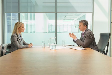 side view of someone sitting in chair - Business people talking in meeting Stock Photo - Premium Royalty-Free, Code: 6113-07243170