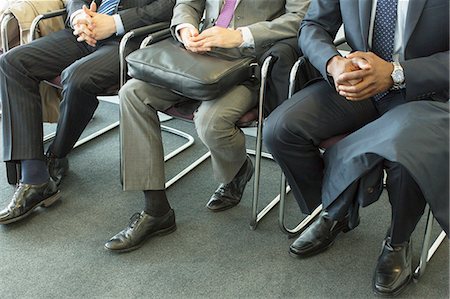 simsearch:6113-07243233,k - Businessmen sitting in waiting area Fotografie stock - Premium Royalty-Free, Codice: 6113-07243185