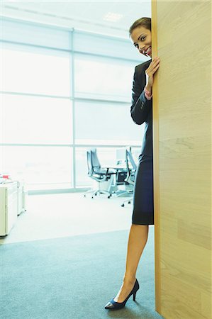 shy (people) - Businesswoman smiling in office Stock Photo - Premium Royalty-Free, Code: 6113-07243122