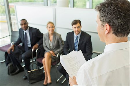 simsearch:6113-07243169,k - Businessman talking to colleagues in office Stock Photo - Premium Royalty-Free, Code: 6113-07243134