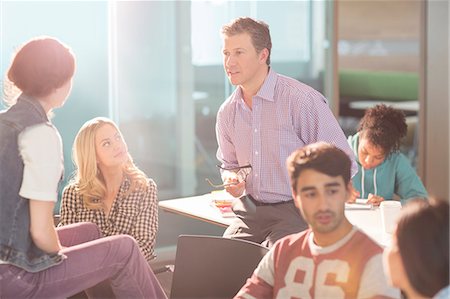 professor with student - Professor and university students talking in classroom Stock Photo - Premium Royalty-Free, Code: 6113-07243294