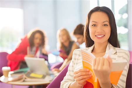 student not child book smile - University student reading in lounge Stock Photo - Premium Royalty-Free, Code: 6113-07243295