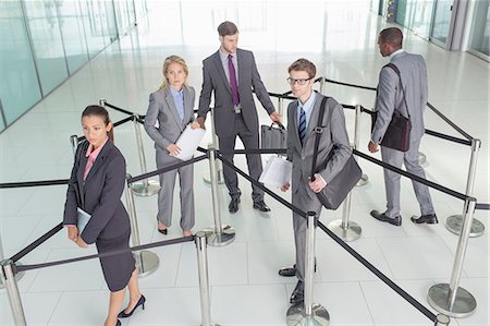 Business people standing in roped-off area Photographie de stock - Premium Libres de Droits, Code: 6113-07243205