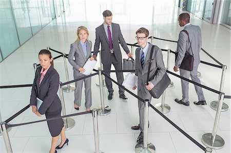 Business people standing in roped-off area Stockbilder - Premium RF Lizenzfrei, Bildnummer: 6113-07243205