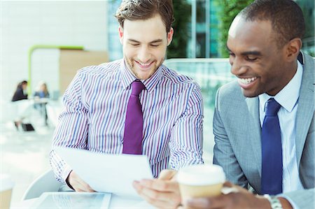 Businessmen talking at cafe Stock Photo - Premium Royalty-Free, Code: 6113-07243221