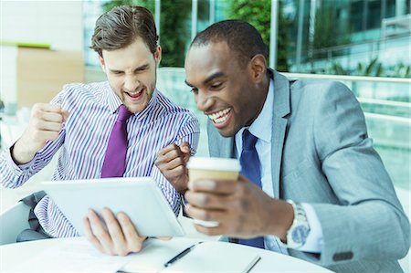 extático - Businessmen cheering at digital tablet Foto de stock - Sin royalties Premium, Código: 6113-07243226