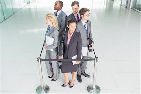 elevated view of a confident businesswoman - Business people standing in roped-off square Stock Photo - Premium Royalty-Free, Code: 6113-07243233