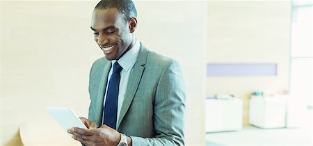 electronic mail - Businessman using digital tablet in office Stock Photo - Premium Royalty-Free, Code: 6113-07243237