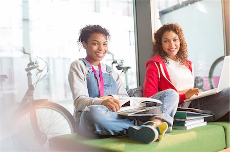 University students smiling on bench Stock Photo - Premium Royalty-Free, Code: 6113-07243369