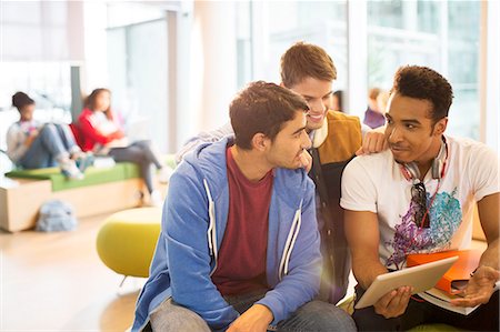 students talking - University students using digital tablet in lounge Stock Photo - Premium Royalty-Free, Code: 6113-07243372