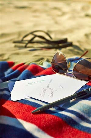 Postcards, sunglasses and sandals at beach Stock Photo - Premium Royalty-Free, Code: 6113-07243445