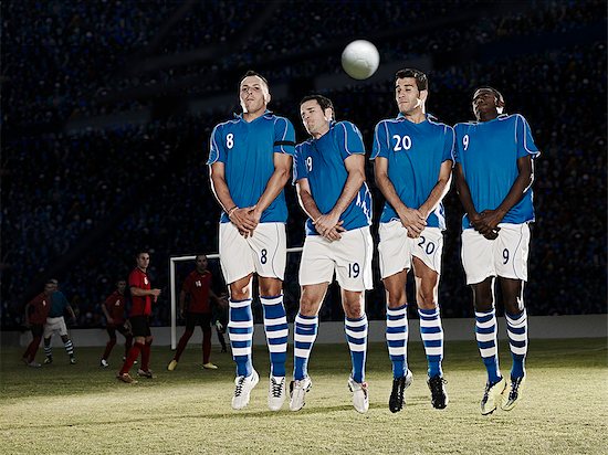 Soccer players jumping on field Stock Photo - Premium Royalty-Free, Image code: 6113-07310570