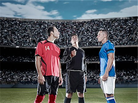 soccer stadium low angle shot - Referee tossing coin in soccer game Stock Photo - Premium Royalty-Free, Code: 6113-07310587