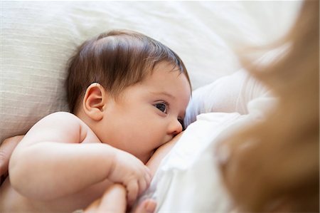 simsearch:614-08684717,k - Mother breast-feeding baby girl Stock Photo - Premium Royalty-Free, Code: 6113-07542384