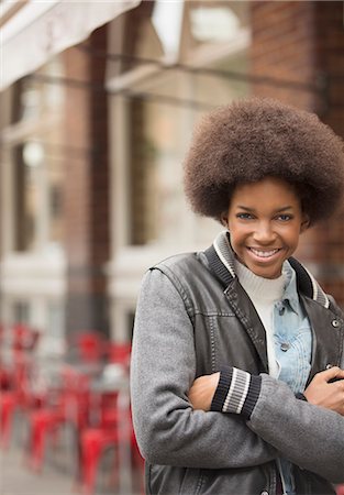 Woman smiling on city street Stock Photo - Premium Royalty-Free, Code: 6113-07542444