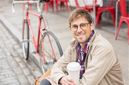 relaxed lifestyle - Man drinking coffee on city street Stock Photo - Premium Royalty-Free, Code: 6113-07542476