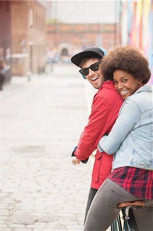 riding (vehicle) - Couple riding bicycle together on city street Stock Photo - Premium Royalty-Free, Code: 6113-07542482