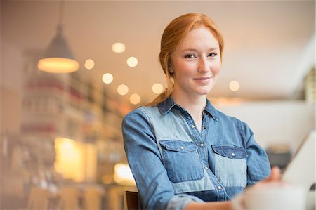 portrait and one person and happy and young adult - Woman holding menu in cafe Stock Photo - Premium Royalty-Free, Code: 6113-07542415