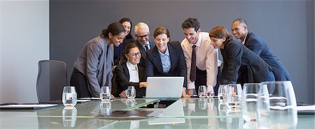 simsearch:6113-07242205,k - Business people using laptop in meeting Stock Photo - Premium Royalty-Free, Code: 6113-07542575