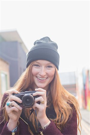 portrait young adult front - Woman using camera on city street Stock Photo - Premium Royalty-Free, Code: 6113-07542511