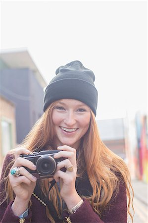 eye contact and camera - Woman using camera on city street Stock Photo - Premium Royalty-Free, Code: 6113-07542511